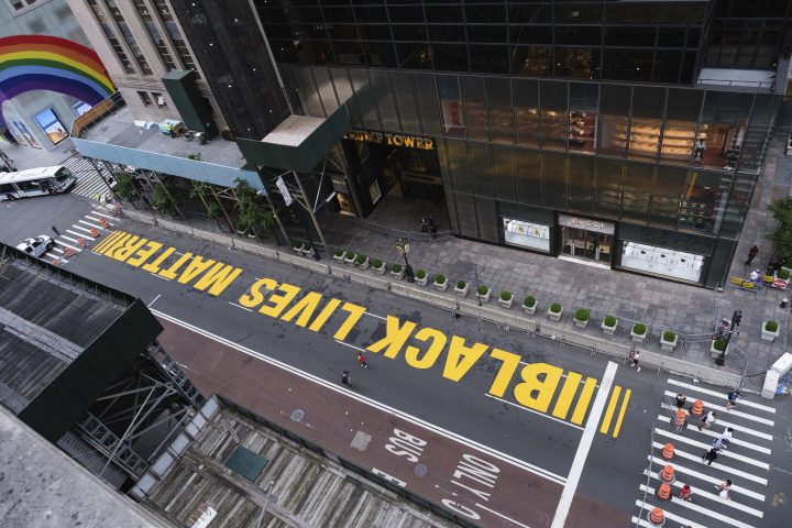 Pedestrians walk on a Black Lives Matter mural painted in front of Trump Tower, Friday, July 10, 2020, in New York. 