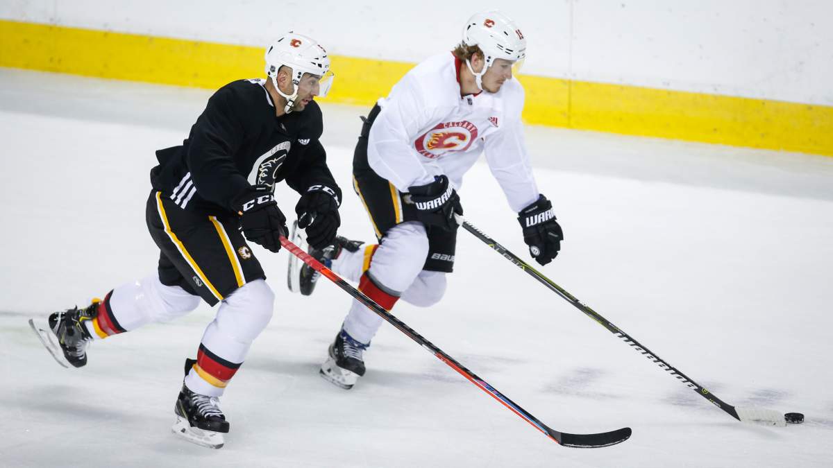 Calgary Flames’ Mark Giordano, left, and Matthew Tkachuk skate during practice in Calgary, Monday, July 13, 2020.