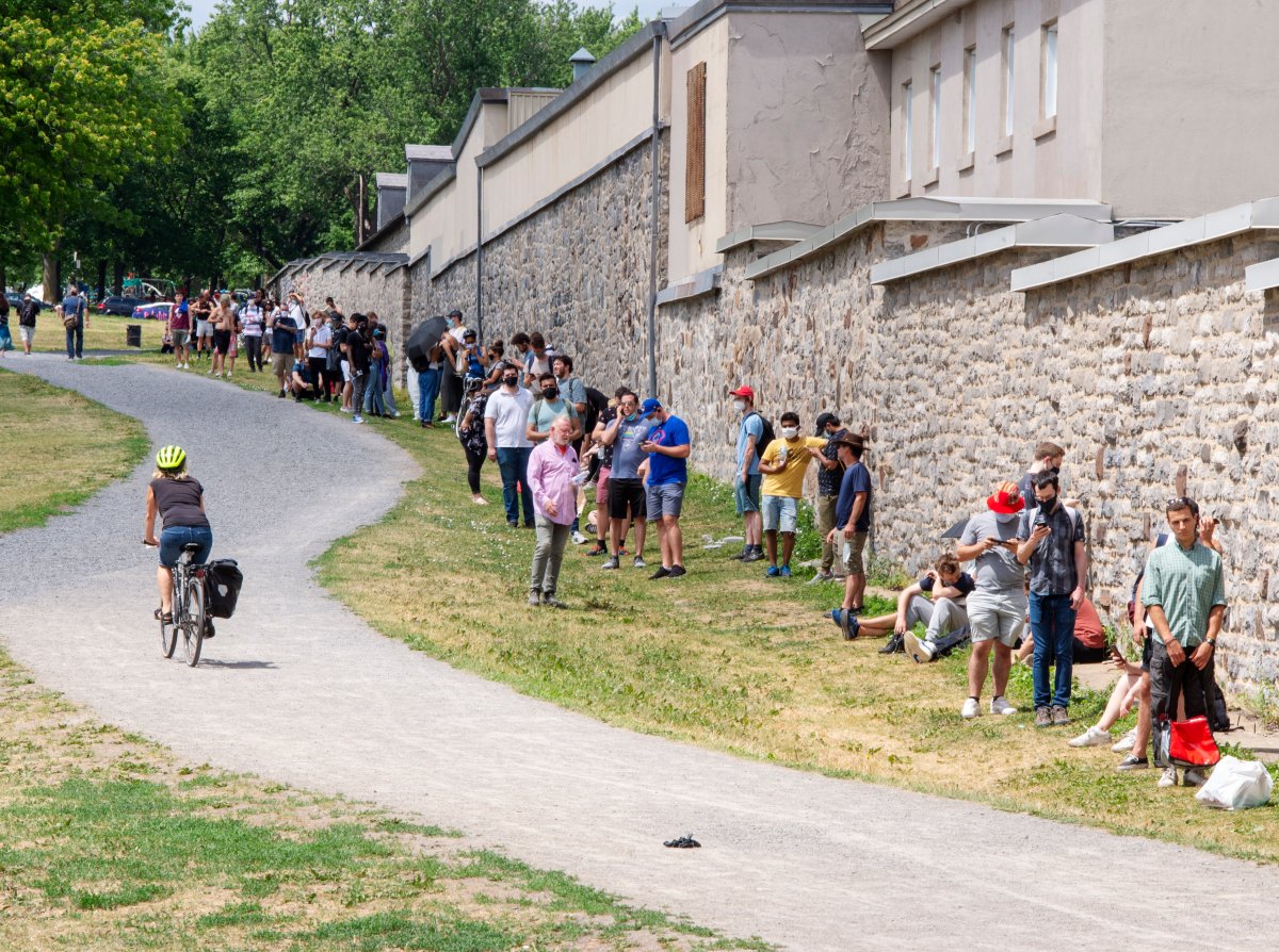 Hundreds of people line up at the Hotel Dieu COVID-19 testing clinic Wednesday, July 15, 2020  in Montreal. The city has recommended that anyone who has been in a bar since July 1, 2020 to get tested. 