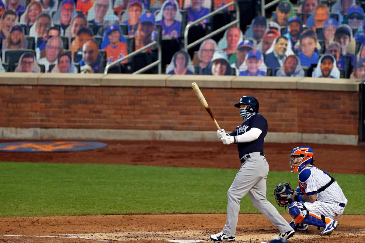 New York Yankees’ Clint Frazier, left, watches his two-run home run against the New York Mets during the fourth inning of a baseball spring training game Saturday, July 18, 2020, in New York.