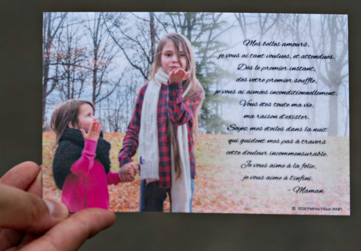 A card distributed by the family depicts Romy, left, and Norah Carpentier, at the funeral home in Levis, Que.,
