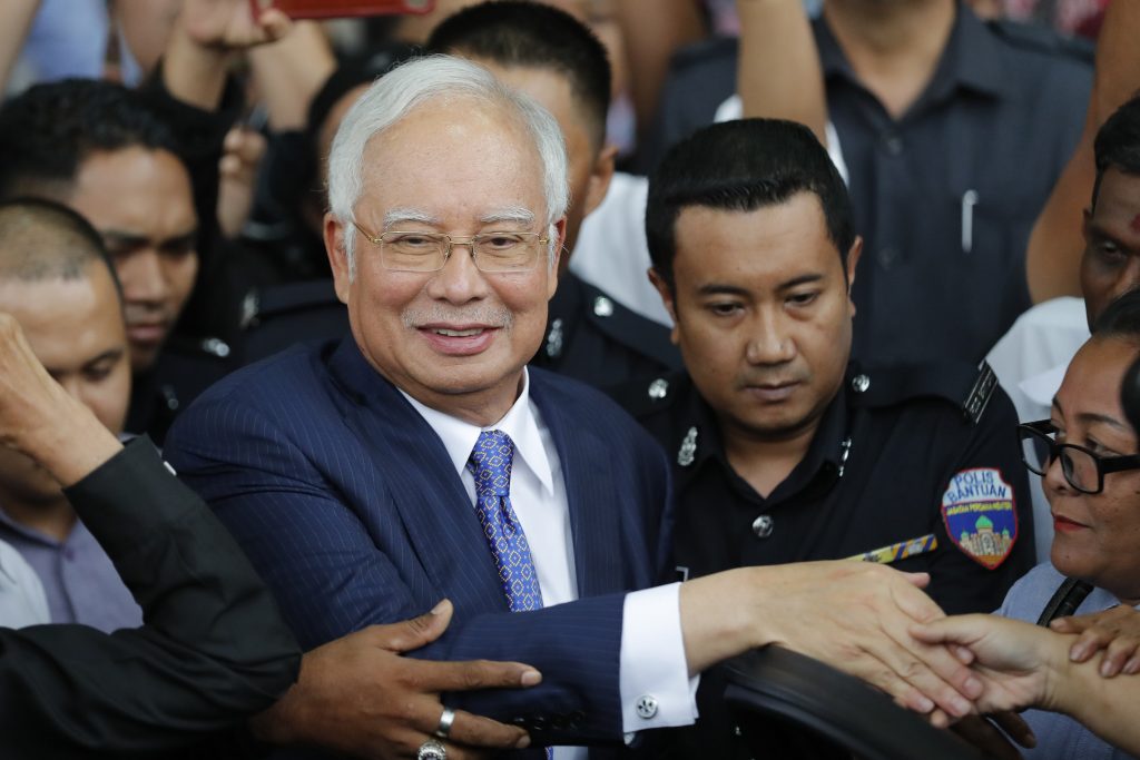 Former Malaysian Prime Minister Najib Razak, center, gets into a car after his court appearance at the Kuala Lumpur High Court in Kuala Lumpur, Malaysia, on April 3, 2019. Najib was found guilty Tuesday, July 28, 2020 in his first corruption trial linked to one of the world’s biggest financial scandals - the billion-dollar looting of the 1MDB state investment fund. 