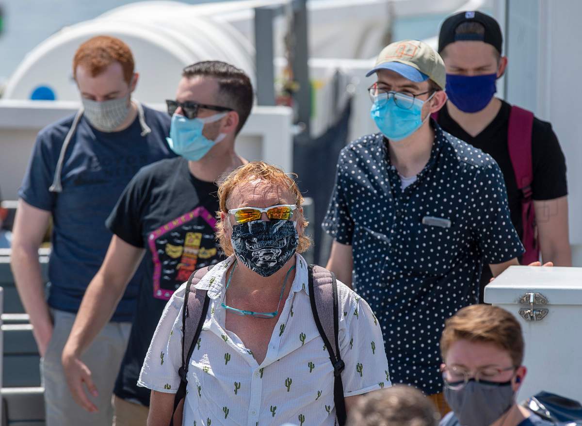 Passengers wear face masks on a Halifax Transit ferry as it arrives in Dartmouth, N.S., on Friday, July 24, 2020.