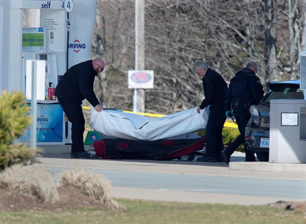 Workers with the medical examiner's office remove a body from a gas bar in Enfield, N.S. on Sunday, April 19, 2020. A coalition of groups devoted to reducing or eradicating gender based violence across Canada is urging Ottawa and Nova Scotia to refrain from using a restorative justice approach for a promised inquiry into the mass killing that claimed the lives of 22 people in the Maritime province.