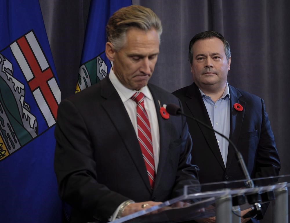 United Conservative Party leader Jason Kenney, right, looks on as MLA Dave Rodney announces his resignation in Calgary, Alta., Sunday, Oct. 29, 2017. A former Alberta legislature member who gave up his seat for Alberta Premier Jason Kenney has a new government job in Texas. Kenney has appointed Dave Rodney to the job of Alberta's agent general. THE CANADIAN PRESS/Jeff McIntosh.
