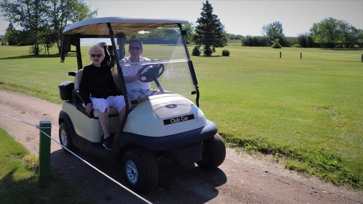 Murray Eckert drives his mother, Eva, to her tee on the Regina Beach Golf Course