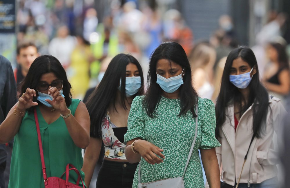 Shoppers wear face coverings to protect themselves from COVID-19 as they walk along Oxford Street in London, Friday, July 24, 2020.  (AP Photo/Frank Augstein)
.