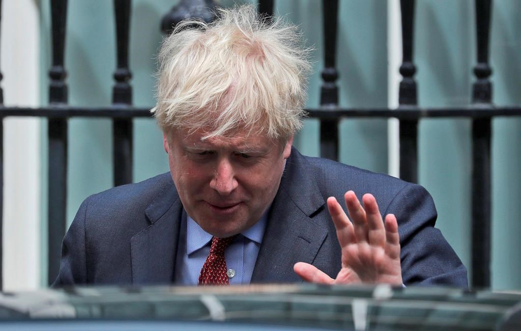 Britain's Prime Boris Johnson leaves 10 Downing Street to attend the weekly Prime Minister's Questions session, in parliament in London, Wednesday, July 15, 2020. (AP Photo/Frank Augstein).
