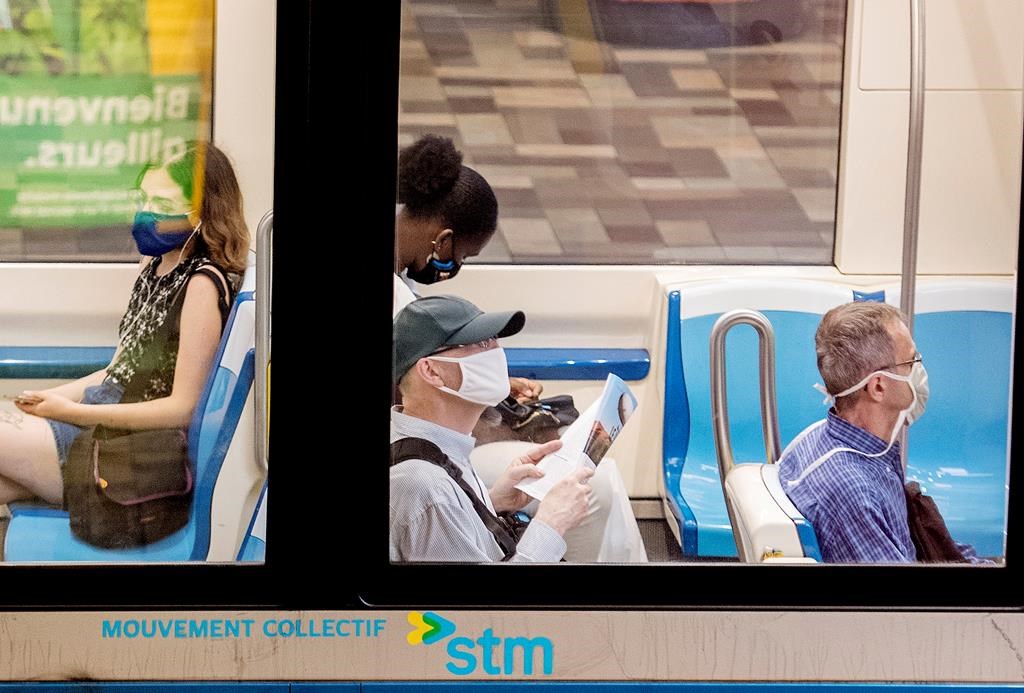 People wear face masks as they commute on a metro in Montreal, Sunday, July 12, 2020.