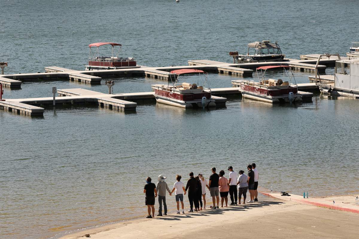 PIRU, Calif., – JULY 13: Cast members from the TV Show “Glee” and friends held hands as they shouted “Say her name – Naya” as they gathered on the Lake Piru boat launch Monday morning. (Al Seib / Los Angeles Times via Getty Images)