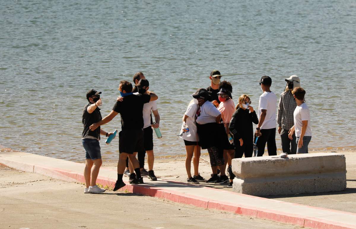 PIRU, Calif., – JULY 13: Cast members from the TV show ‘Glee’ and friends comfort each other as they gathered on the Lake Piru boat launch Monday morning just as Ventura County Sheriffs Search and Rescue dive team located a body Monday morning in Lake Piru. (Al Seib / Los Angeles Times via Getty Images)