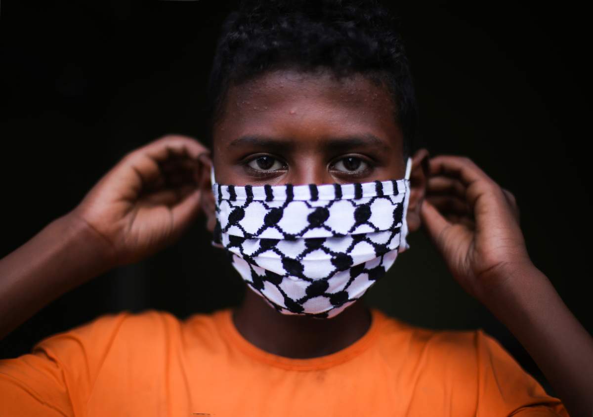 Child wearing a face mask. (Photo by: Youssef Masoud/INA Photo Agency/Universal Images Group via Getty Images).