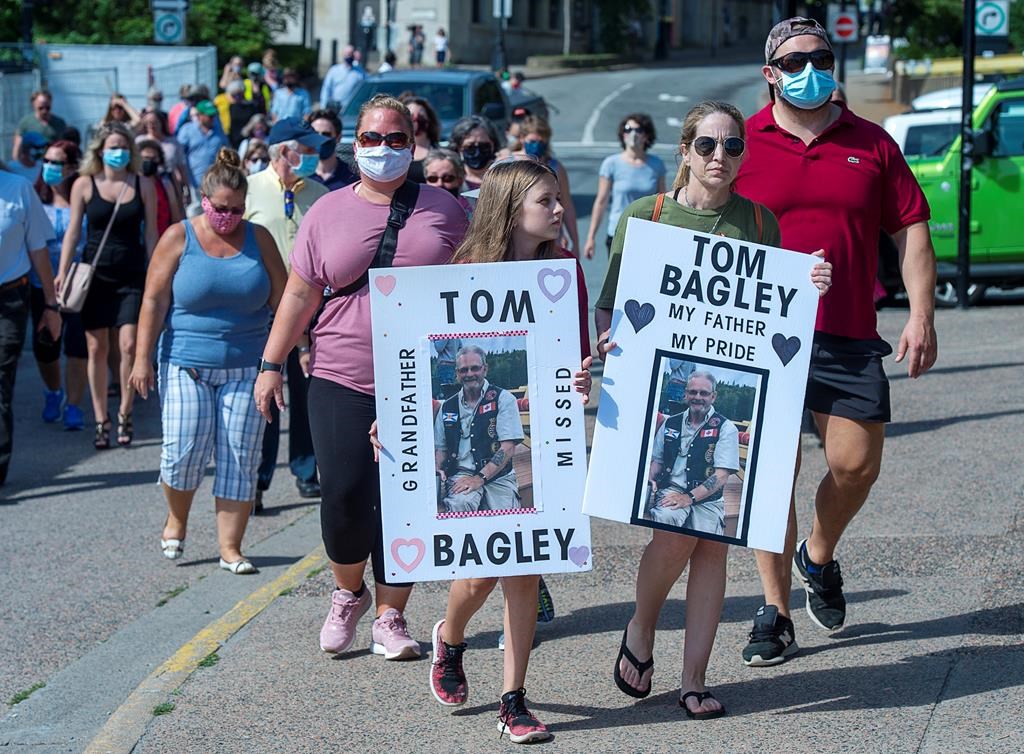 Family and friends of victims of the deadly Nova Scotia mass shootings display their appreciation after an inquiry was announced, in Halifax on Wednesday, July 29, 2020. The federal and provincial governments will launch an inquiry instead of a review that had no power to compel testimony or deliver binding recommendations. THE CANADIAN PRESS/Andrew Vaughan.