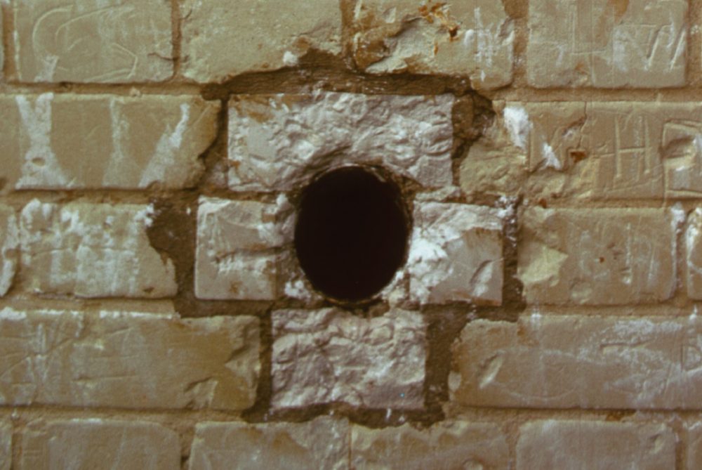 A hole is shown in a brick wall in this file photo.