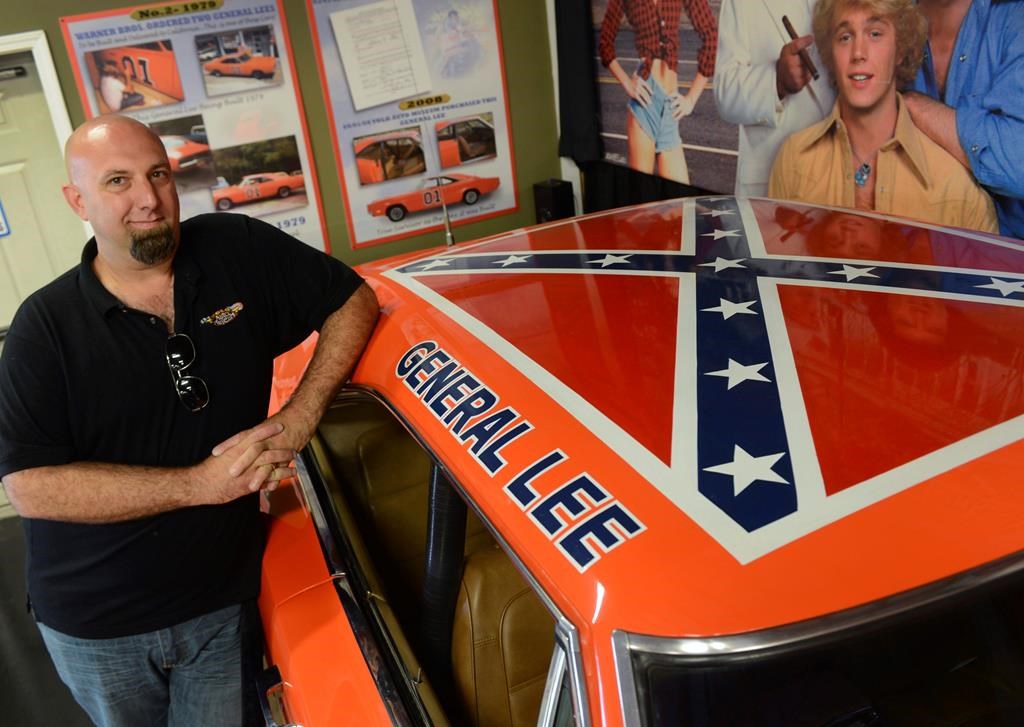 Volo Auto Museum owner and director Brian Grams poses with one of the museum’s 1969 Dodge Chargers driven in the television series ‘The Dukes of Hazzard’ in Volo, Ill., on June 26, 2015. Grams said they will continue to display the car, nicknamed “General Lee,” despite growing criticism of the Confederate battle flag painted on the car’s roof.
