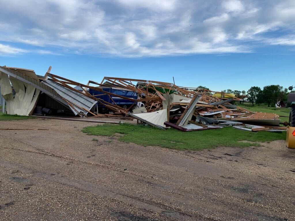 Damaged buildings on Corey Schroeder’s farm on Monday.