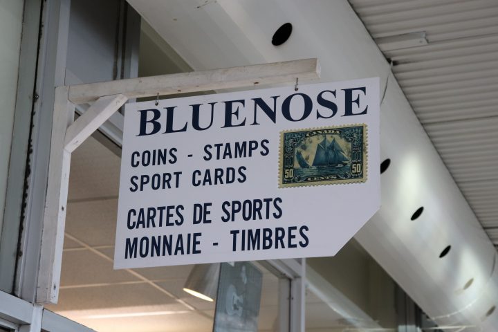 The Bluenose Collectible sign, with an image of the Bluenose stamp, hangs over the store’s entrance in the Plaza Pointe-Claire on Tuesday, July 21, 2020. Pamela Pagano/ Global News