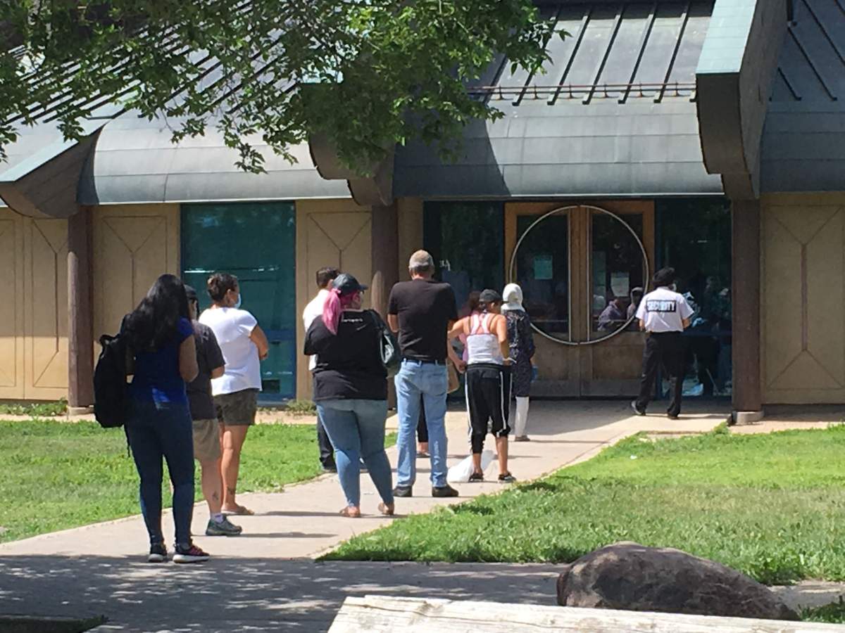 People line up for COVID-19 testing at Thunderbird House on Main Street in Winnipeg Wednesday.