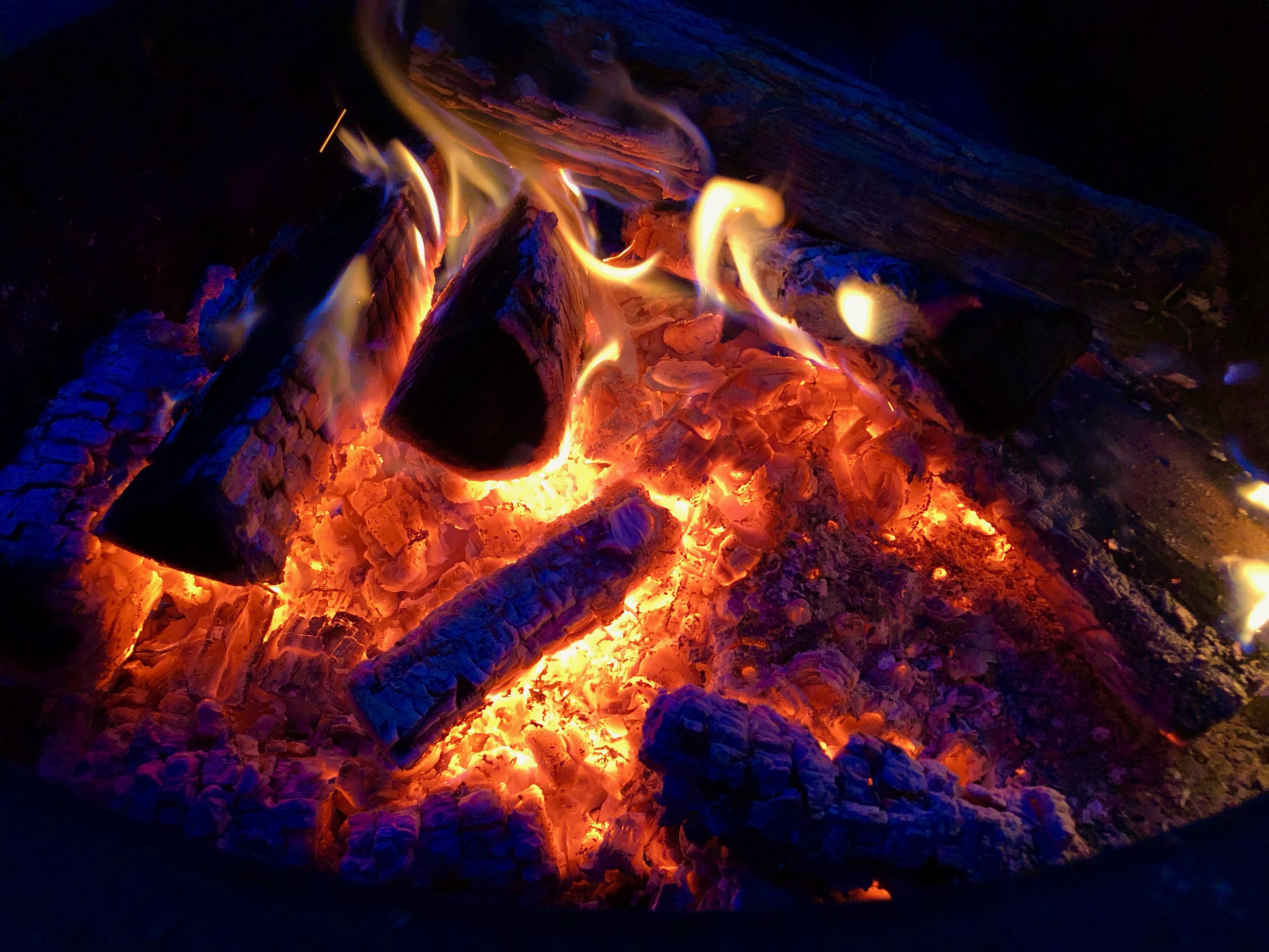 Barbecue Over Wood Fired Grill Near Stream by Cavan Images