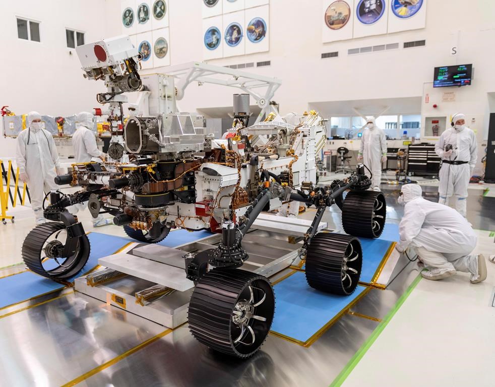 Engineers monitor a driving test for the Mars rover Perseverance in a clean room at the Jet Propulsion Laboratory in Pasadena, Calif., in this Dec. 17, 2019 photo made available by NASA. A Canadian scientist says helping NASA with a mission to Mars that will look for signs of life is the fulfillment of a childhood dream. Chris Herd of the University of Alberta is one of the advisors on a Mars probe that will pick up rocks on the red planet, study them, then seal them away to be picked up on a later mission. Herd says Perseverance, the latest Mars rover, is being sent to an ancient lake bed on the theory that those places are most likely to contain signs of life. THE CANADIAN PRESS/AP, HO - NASA, J. Krohn *MANDATORY CREDIT*.