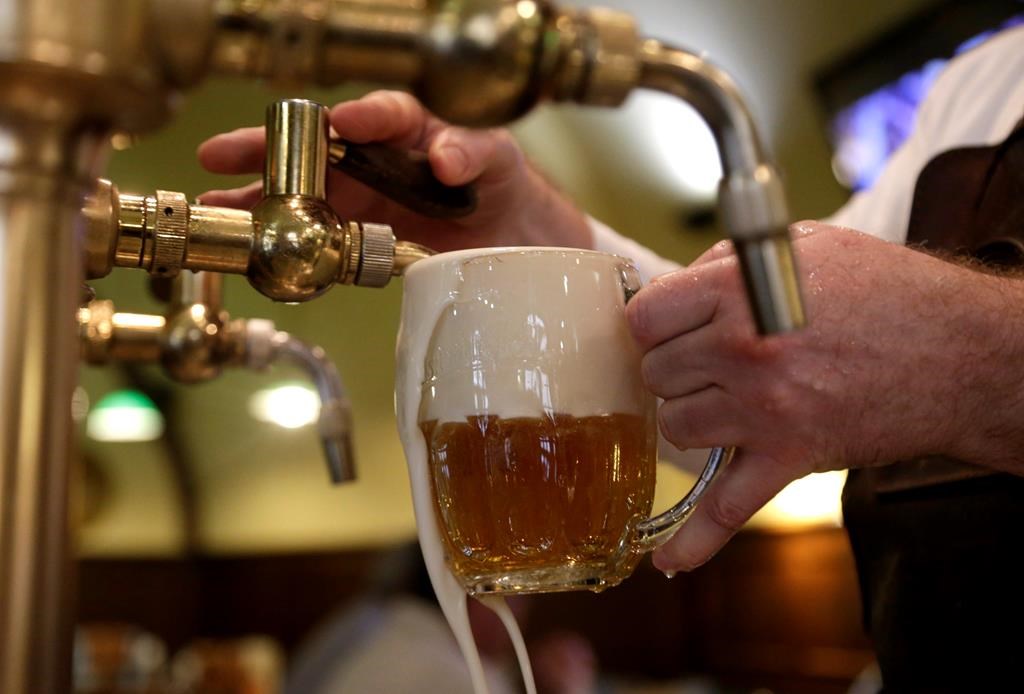 A bartender fills a glass of beer at a pub in Prague, Czech Republic, Tuesday, Feb. 2, 2016.