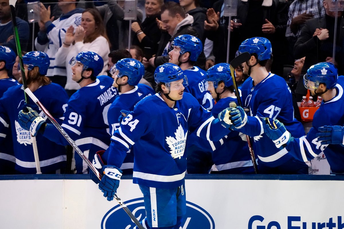 Toronto Maple Leafs centre Auston Matthews (34) celebrates his goal with the bench during first-period NHL hockey action against the Vancouver Canucks, in Toronto, Saturday, Feb. 29, 2020.