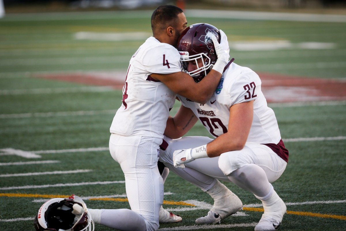 McMaster Marauders' Justice Allin, left, and Andrew Pacheco comfort each other after losing to the University of Calgary Dinos in the U Sports Mitchell Bowl football game in Calgary, Saturday, Nov. 16, 2019.