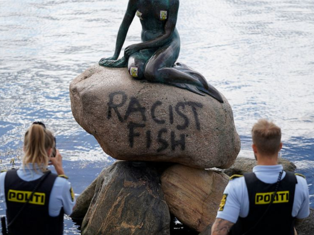 Police stand by the statue of the Little Mermaid, after it was vandalized, in Copenhagen, Denmark, Friday, July 3, 2020. 
