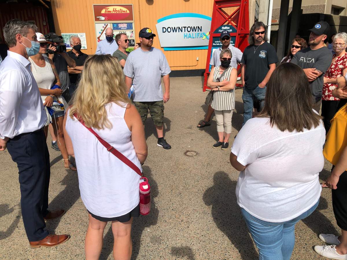 Relatives of those killed in the Nova Scotia mass shooting in April gather together before a march to the legislature in Halifax on July 29, 2020.
