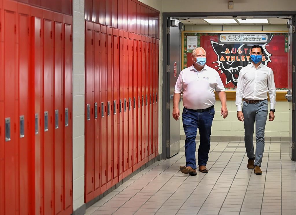 Ontario Premier Doug Ford, left, and Education Minister Stephen Lecce walk the hallway before making an announcement regarding the governments plan for a safe reopening of schools in the fall due to the COVID-19 pandemic at Father Leo J Austin Catholic Secondary School in Whitby, Ont., on Thursday, July 30, 2020. Denette.