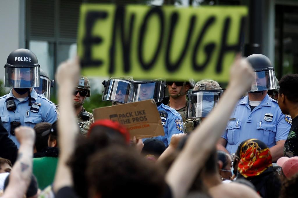 FILE - In this June 1, 2020, file photo, protesters rally as Philadelphia Police officers and Pennsylvania National Guard soldiers look on in Philadelphia, over the death of George Floyd, a black man who was in police custody in Minneapolis.