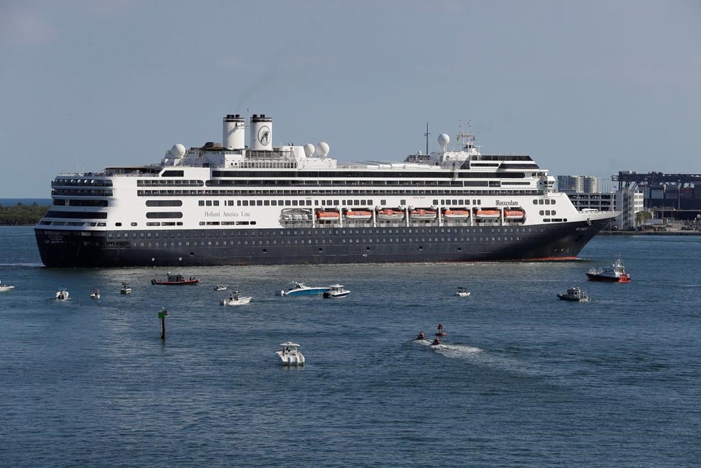 FILE - The cruise ship Rotterdam turns as it prepares to dock at Port Everglades, Thursday, April 2, 2020, in Fort Lauderdale, Fla. Federal health officials are extending the U.S. ban on cruise ships through the end September as coronavirus infections rise in most U.S. states, including Florida. The Centers for Disease Control and Prevention announced Thursday, July 16, 2020 that it was extending a no-sail order that had been scheduled to expire July 24.