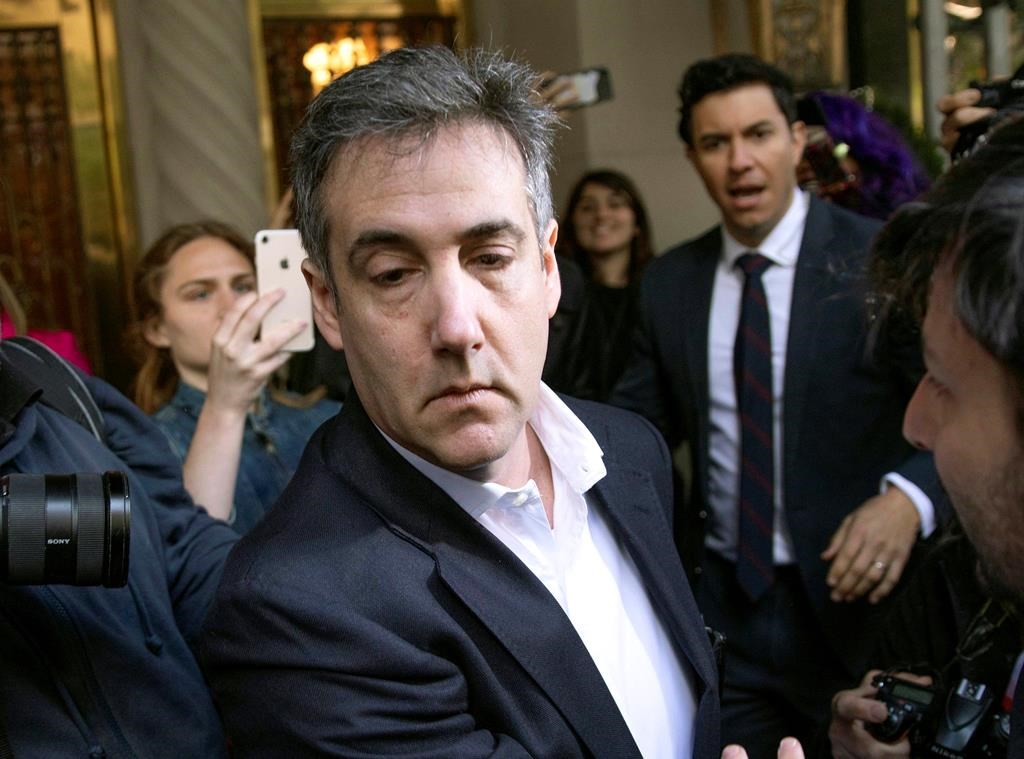FILE - In this May 6, 2019, file photo, Michael Cohen, former attorney to President Donald Trump, leaves his apartment building before beginning his prison term in New York.l Cohen, was returned to federal prison, weeks after his early release to serve the remainder of his sentence at home because of the coronavirus pandemic, the federal Bureau of Prisons said Thursday, July 9, 2020.