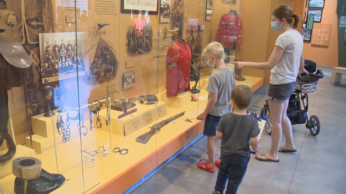Katrina Robinson and her children are the first visitors to the reopened RCMP Heritage Centre on July 8, 2020.