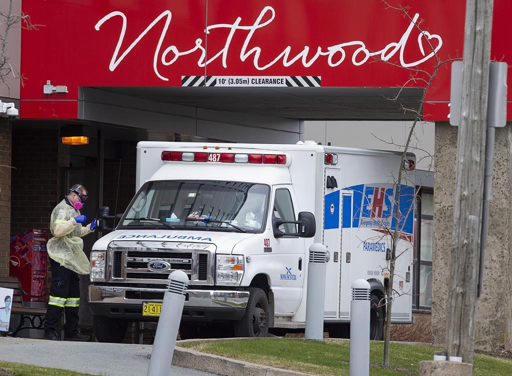 A paramedic walks around an ambulance at Northwood Manor, one of the largest nursing homes in Atlantic Canada with 585 residents, in Halifax on Friday, May 1, 2020. 