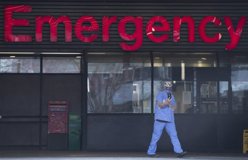 A health care worker is seen outside the emergency department of the Vancouver General Hospital in Vancouver on March 30, 2020.
