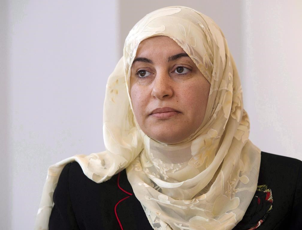 Rania El-Alloul takes part in a news conference Friday, March 27, 2015, in Montreal. A Quebec judge who refused to allow a Muslim woman to appear in court wearing a hijab in 2015 has apologized.