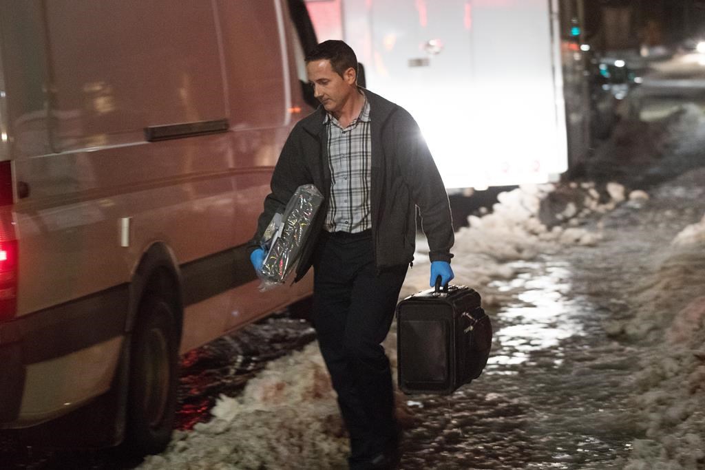 Police officer carries evidence after arrest of youth on terrorism charges in Kingston, Ont., on Thursday Jan. 24, 2019.