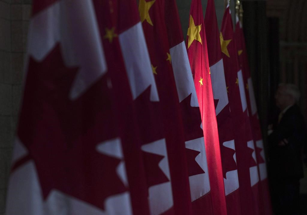 A Chinese flag is illuminated by sunshine in the Hall of Honour on Parliament Hill in Ottawa, Thursday, September 22, 2016.