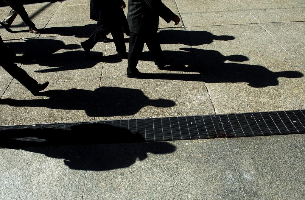 People walk in Toronto's financial district on Monday, Feb. 27, 2012.