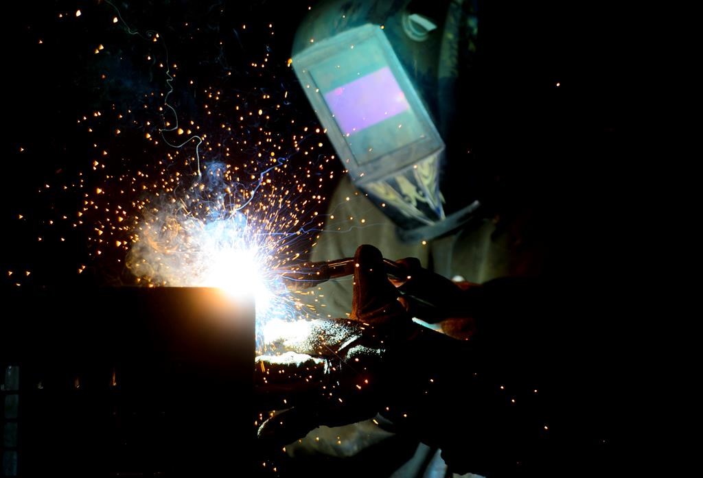 A welder fabricates a steel structure at an iron works facility in Ottawa on Monday, March 5, 2018.