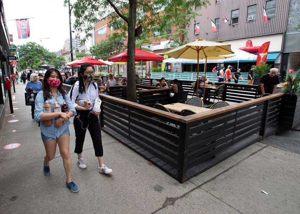 A handful of diners are seen on restaurant patios, Tuesday, July 21, 2020 in Montreal. A new initiative aims to accelerate Montreal's economic recovery. Tuesday, Sept. 8, 2020.