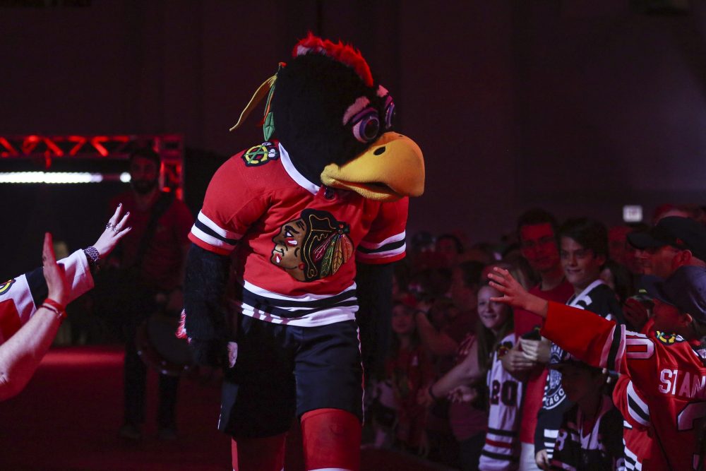 Tommy Hawk, the Chicago Blackhawks’ mascot, throws jerseys toward fans during opening ceremonies at the team’s convention in Chicago, Friday, July 26, 2019.
