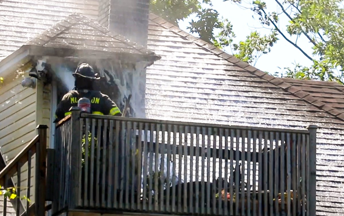Members of the Moncton Fire Department battle a blaze at a home on Dominion Street on Monday July 13, 2020. 