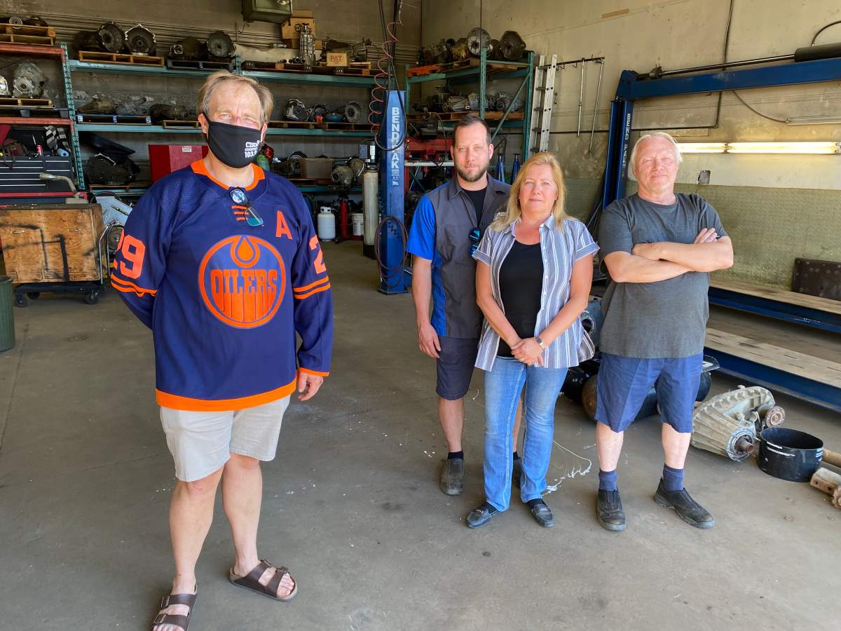 Chris Scheetz poses with ABC Muffler & Hitch and Clutch and Grab Transmission team members