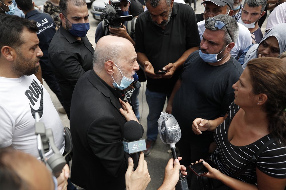 Amin Sherri, a Lebanese lawmaker of the Hezbollah bloc, center, speaks with families of the victims who were missing from the Aug. 4 explosion that hit the seaport of Beirut, Lebanon, Thursday, Aug. 6, 2020. For many, the Iran-backed Hezbollah now stands at the top of Lebanon’s sectarian-based system of power — and so is complicit in the corruption many blame for the port disaster and for driving the country into near bankruptcy. 