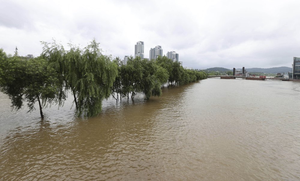 A part of a park near Han river is flooded after heavy rain in Seoul, South Korea, Sunday, Aug. 2, 2020. South Korean Meteorological Administration issued a warning of heavy rain for Seoul and central area.