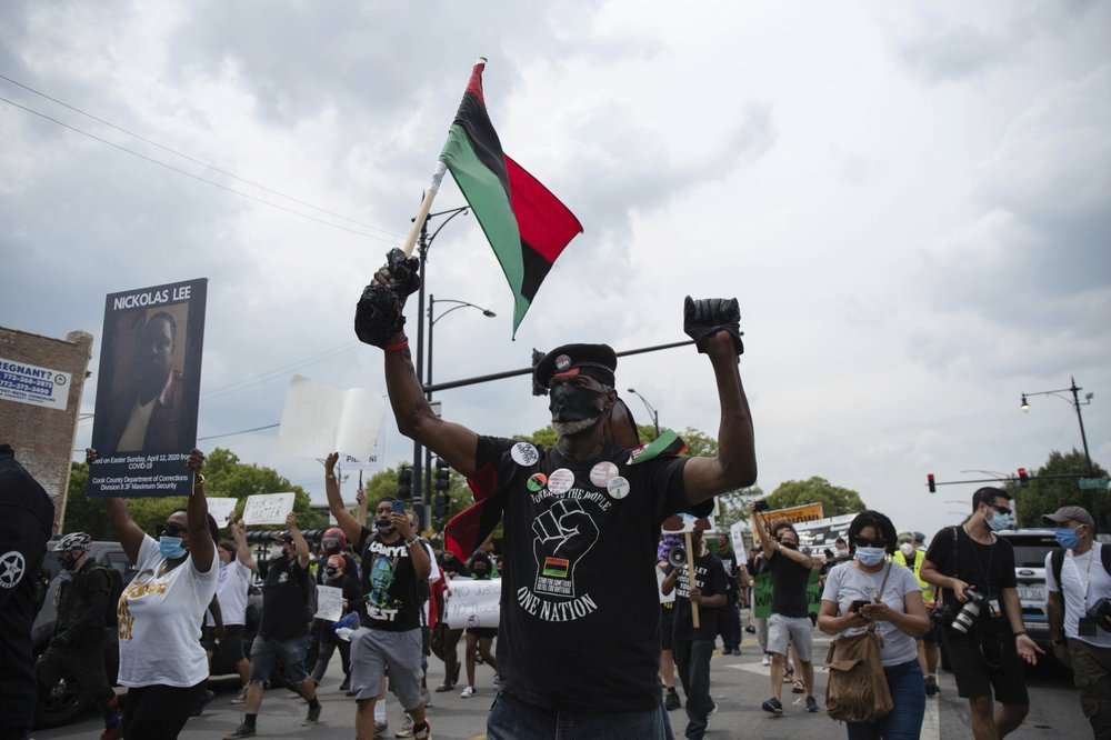 About 200 anti-police brutality protesters march in the neighborhood of Bronzeville, in Chicago, Saturday, Aug. 15, 2020. Protesters walked from Bronzeville to Grant Park, after police prohibited them from marching along the Dan Ryan Expressway. 