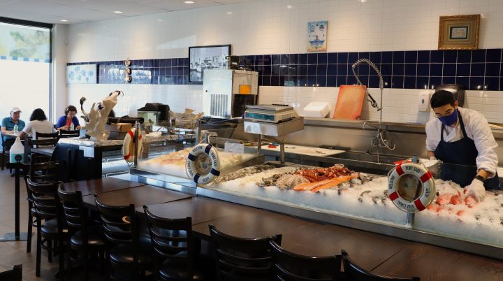Mohamed Gawish, employee of Le Canal and son of Abouselima, works while the Mikail family eats lunch on Wednesday, Aug. 19, 2020. Pamela Pagano/Global News.