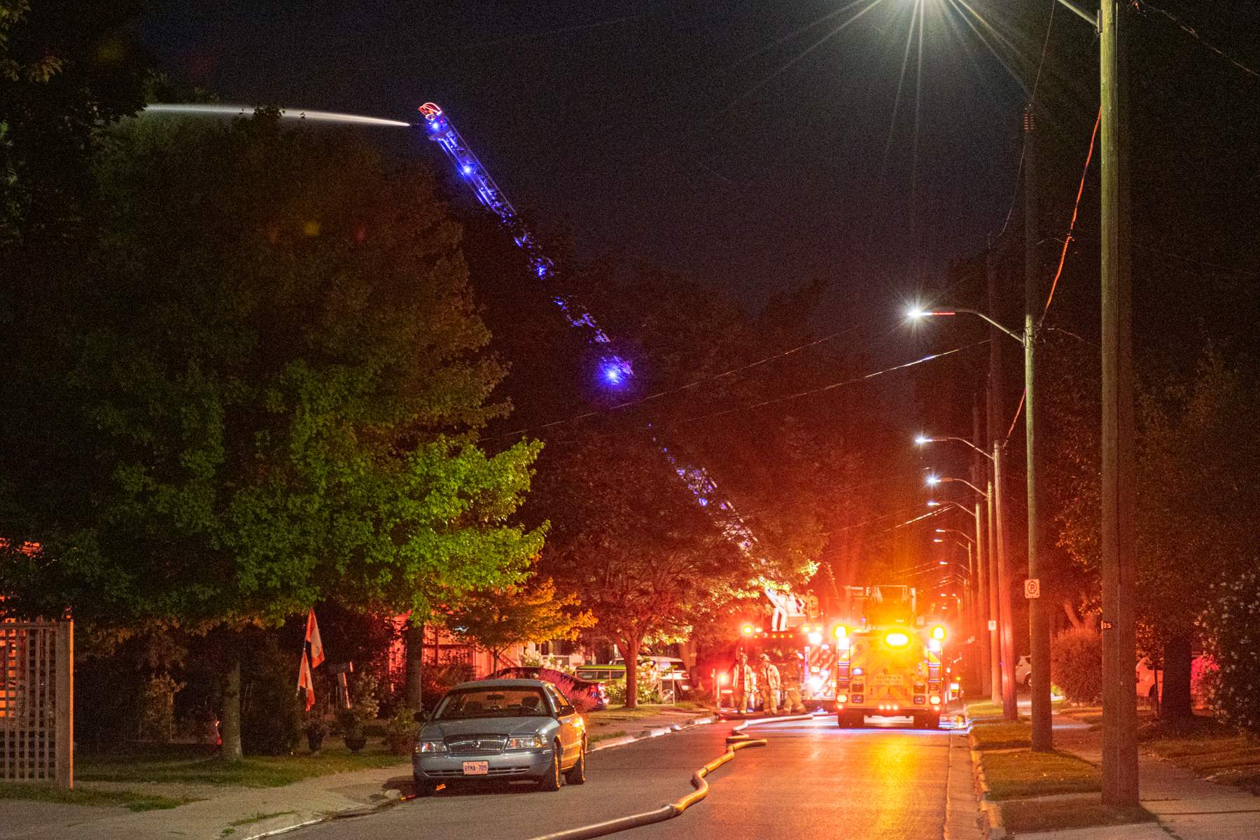 Fire crews on Charlotte Street work to douse flames following the Woodman Avenue explosion, London, Ont., on Aug. 15, 2019.